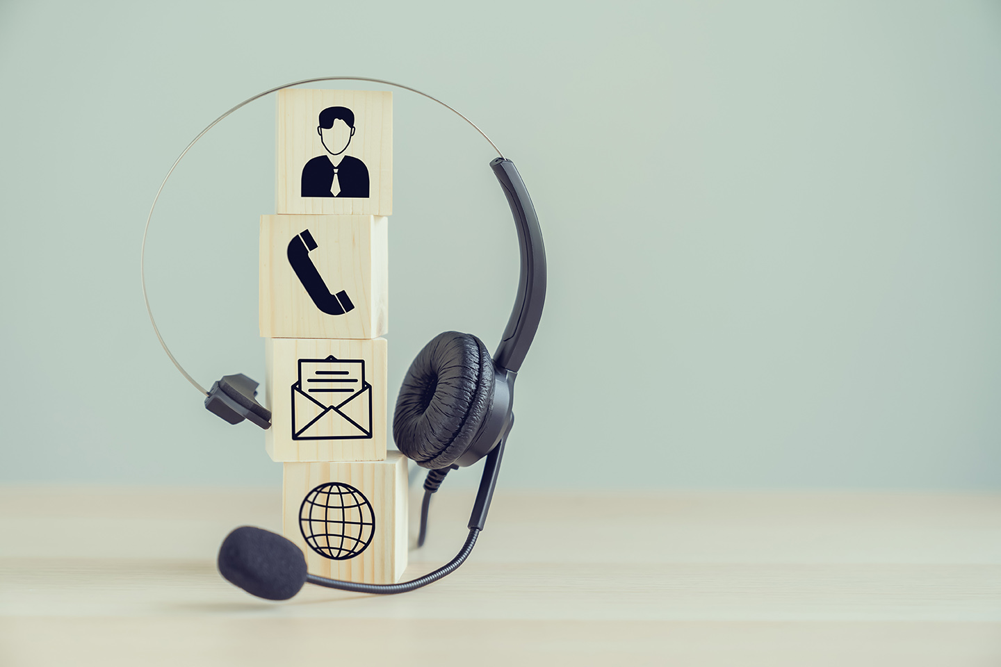 VOIP headset and Icon communication on the wood block.